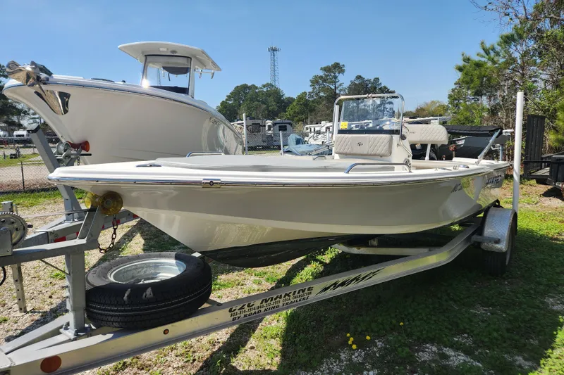 Slide: The Image of 2021 Sea Pro 172 Bay boat on trailer, parked outdoors under clear sky. - 2