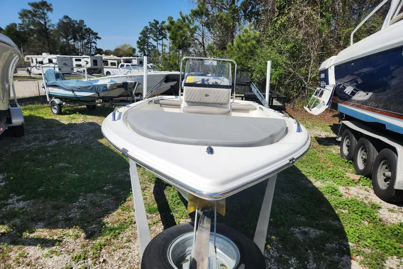 Slide: The Image of 2021 Sea Pro 172 Bay boat displayed outdoors, surrounded by trees and other boats. - 5