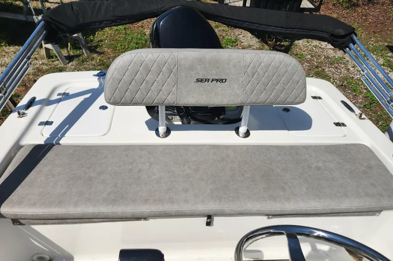 Slide: The Image of 2021 Sea Pro 172 Bay boat interior with gray cushioned seating and steering wheel. - 9