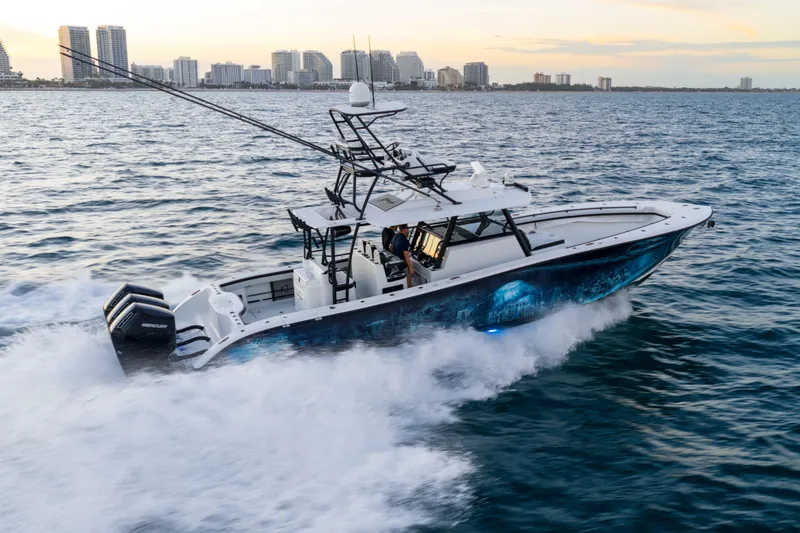 Slide: The Image of 2023 Yellowfin 42 Offshore boat cruising on ocean near city skyline. - 13