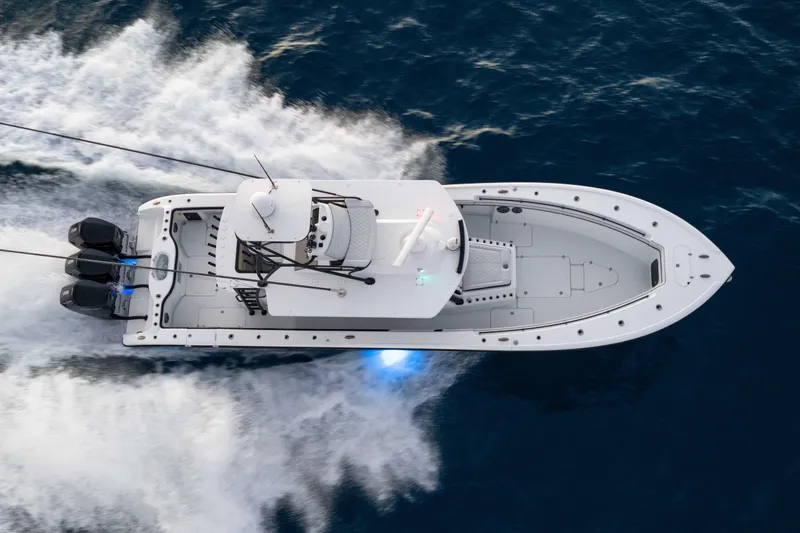 Slide: The Image of 2023 Yellowfin 42 Offshore boat cruising on open water, aerial view. - 14