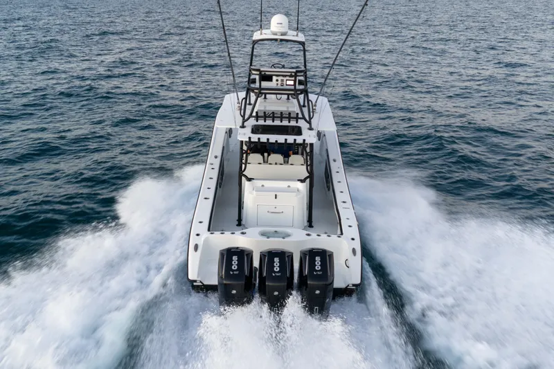 Slide: The Image of 2023 Yellowfin 42 Offshore boat cruising on open water with powerful engines. - 16