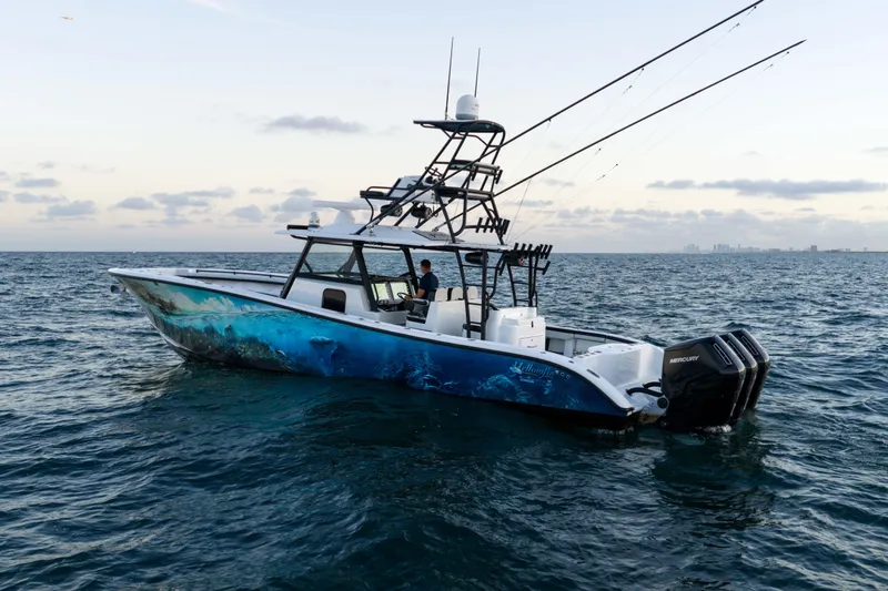 Slide: The Image of 2023 Yellowfin 42 Offshore boat on open water, featuring fishing rods and Mercury engines. - 2
