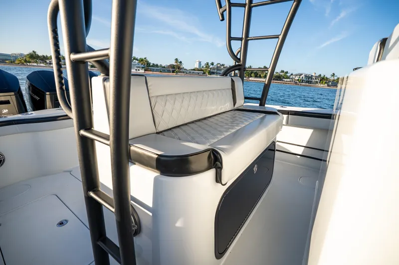 Slide: The Image of 2023 Yellowfin 42 Offshore boat interior with cushioned seating and ocean view. - 25