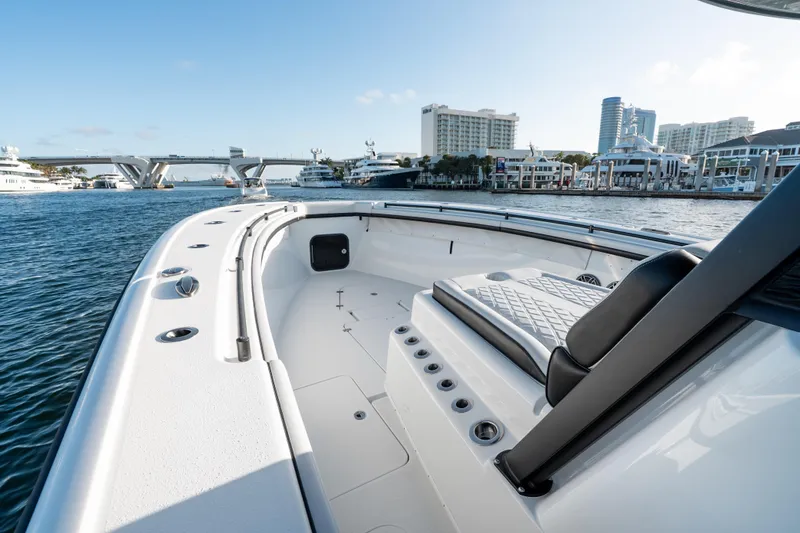 Slide: The Image of 2023 Yellowfin 42 Offshore boat on water near city skyline and bridge. - 29