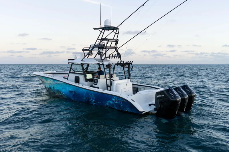 Slide: The Image of 2023 Yellowfin 42 Offshore boat on open sea with triple Mercury engines. - 3