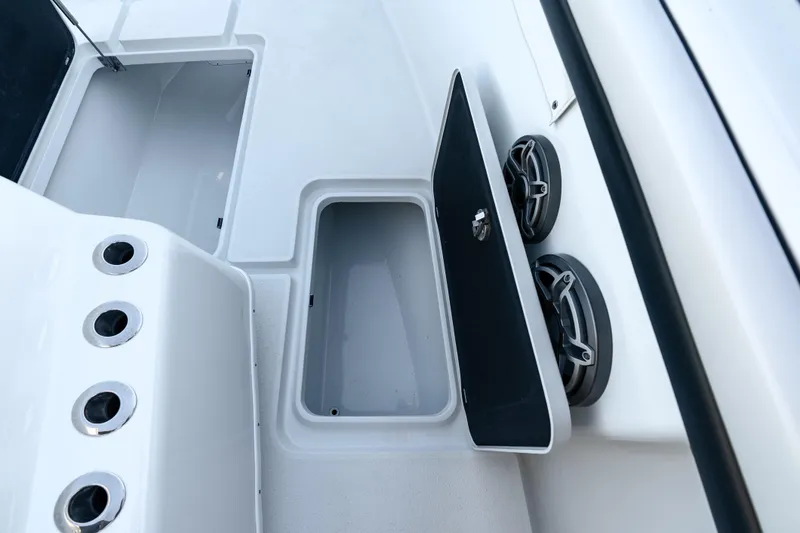 Slide: The Image of 2023 Yellowfin 42 Offshore boat storage compartment with open hatch and speakers. - 35