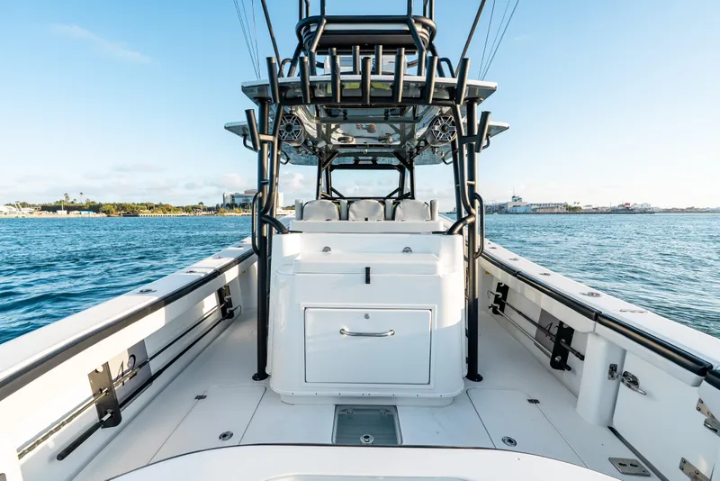 Slide: The Image of 2023 Yellowfin 42 Offshore boat on water, showcasing spacious deck and sleek design. - 37