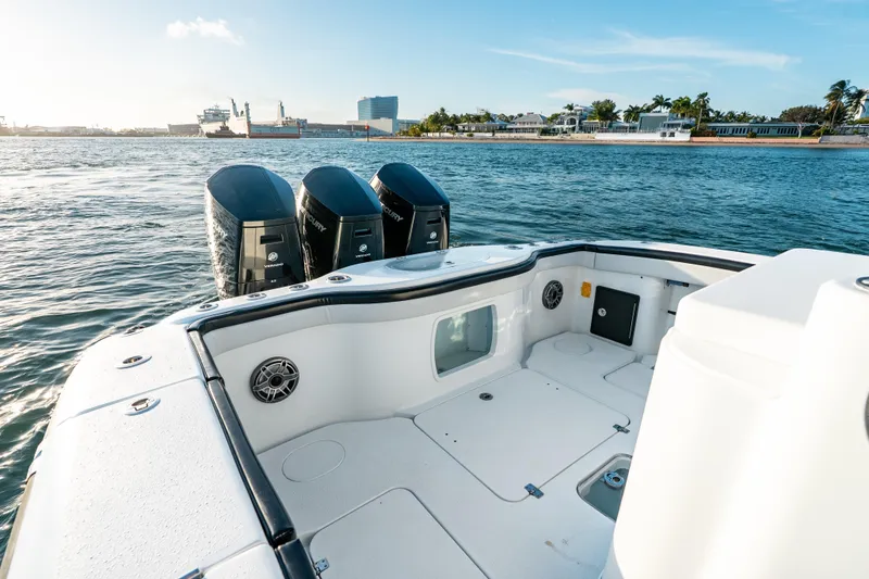 Slide: The Image of 2023 Yellowfin 42 Offshore boat with triple Mercury engines on open water. - 38