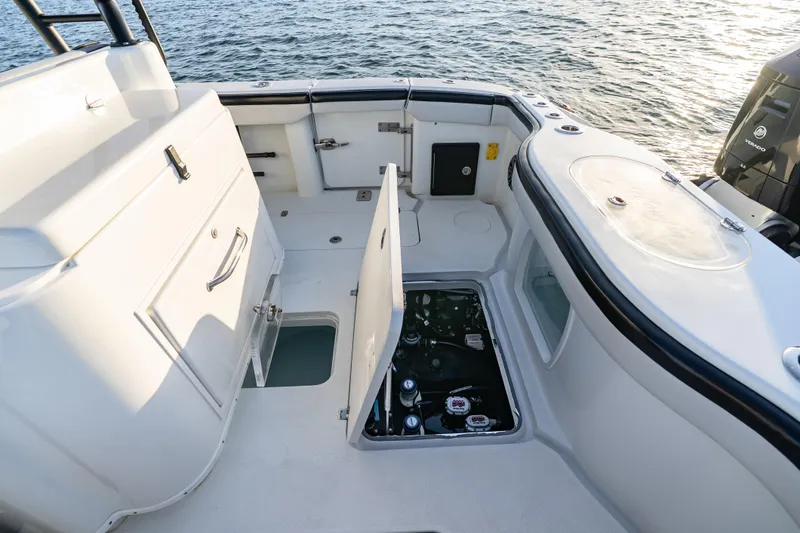 Slide: The Image of 2023 Yellowfin 42 Offshore boat deck with open hatch, revealing engine compartment. - 42
