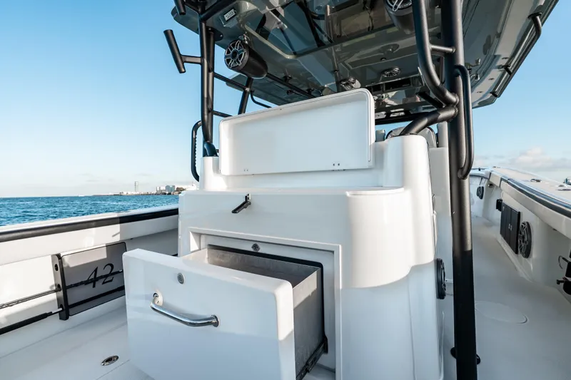 Slide: The Image of 2023 Yellowfin 42 Offshore boat interior with open storage compartment, ocean view. - 44