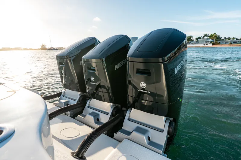Slide: The Image of Triple Mercury Verado engines on 2023 Yellowfin 42 Offshore boat in sunny waters. - 45