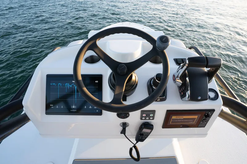 Slide: The Image of Helm of 2023 Yellowfin 42 Offshore boat with modern controls and navigation display. - 50