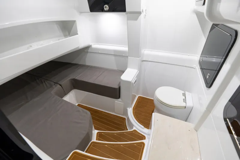 Slide: The Image of 2023 Yellowfin 42 Offshore cabin interior with seating and marine toilet. - 53
