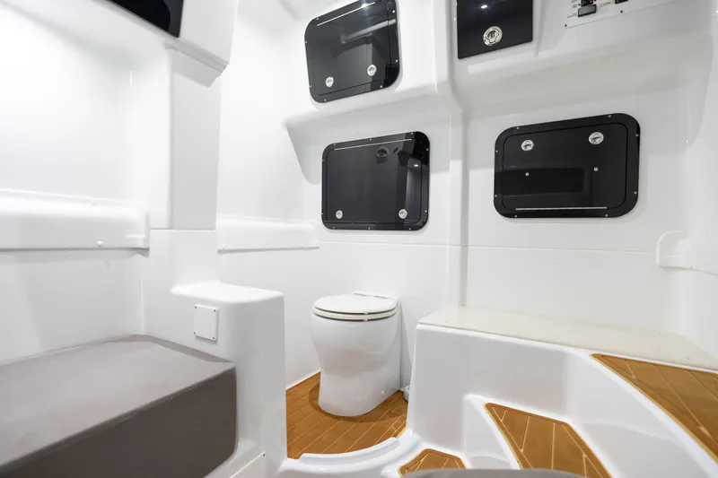 Slide: The Image of 2023 Yellowfin 42 Offshore boat interior with modern bathroom and storage compartments. - 54