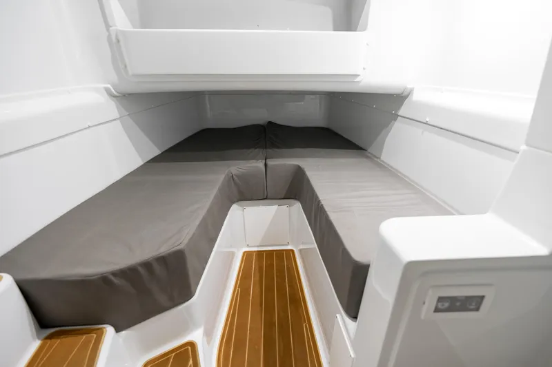 Slide: The Image of 2023 Yellowfin 42 Offshore cabin interior with cushioned seating and wooden flooring. - 55