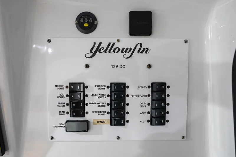 Slide: The Image of Control panel of 2023 Yellowfin 42 Offshore boat with labeled switches and buttons. - 56