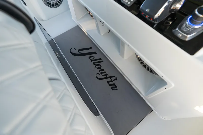 Slide: The Image of 2023 Yellowfin 42 Offshore boat interior with branded mat and control panel. - 58