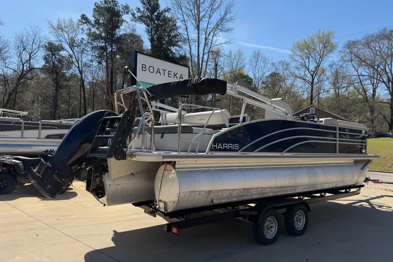 Slide: The Image of 2025 Harris Sunliner 230 pontoon boat on trailer at Boateka dealership. - 3
