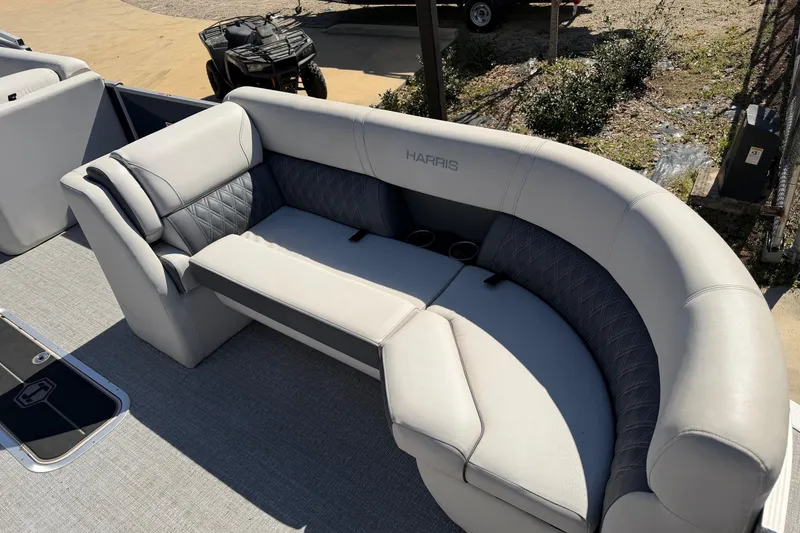 Slide: The Image of Luxurious seating on 2025 Harris Sunliner 230 pontoon boat, featuring elegant upholstery and cup holders. - 6