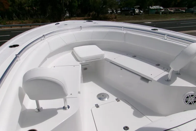 Slide: The Image of 2026 Sportsman Open 232 Center Console boat interior with white seating and storage compartments. - 12
