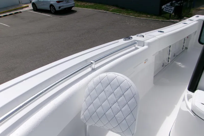 Slide: The Image of 2026 Sportsman Open 232 Center Console boat interior with quilted seating and rod holders. - 14
