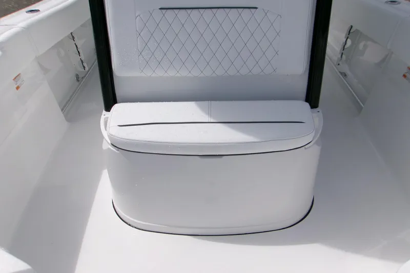 Slide: The Image of 2026 Sportsman Open 232 Center Console boat seating area with white cushioned bench. - 16