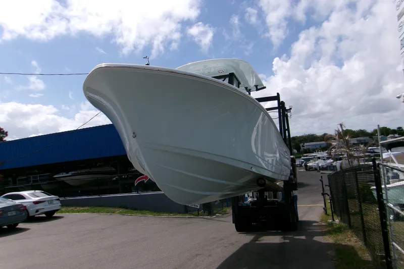 Slide: The Image of 2026 Sportsman Open 232 Center Console boat on a lift at a marina. - 3