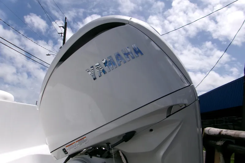 Slide: The Image of 2026 Sportsman Open 232 Center Console with Yamaha outboard motor under blue sky. - 4