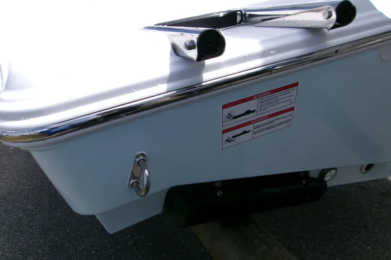 Slide: The Image of 2026 Sportsman Open 232 Center Console boat stern with warning labels and hardware. - 5