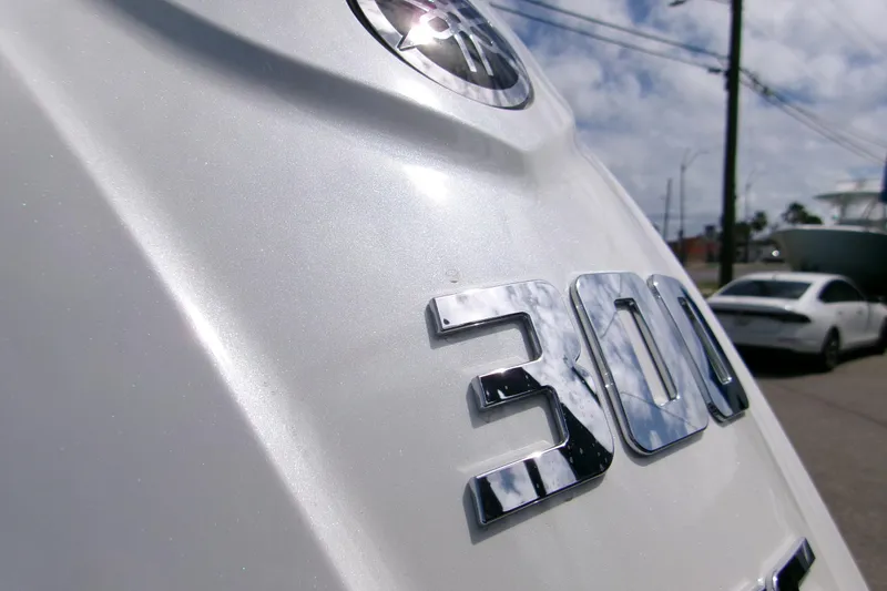 Slide: The Image of Close-up of a 2026 Sportsman Open 232 Center Console boat engine with "300" emblem. - 6