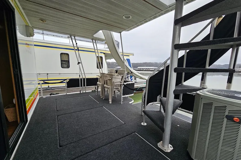 Slide: The Image of Outdoor deck of 2002 Lakeview 16x60 houseboat with spiral staircase and seating area. - 11