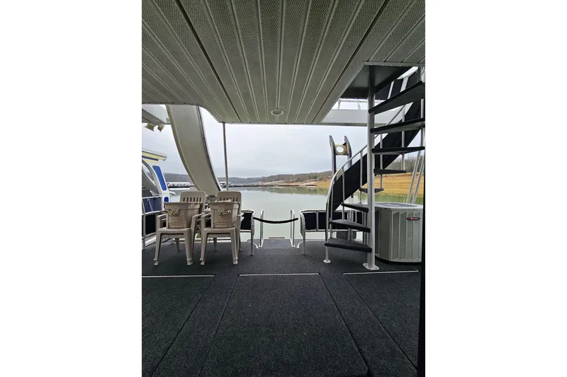 Slide: The Image of Houseboat deck with spiral staircase, chairs, and lake view; Lakeview 16x60, 2002 model. - 13