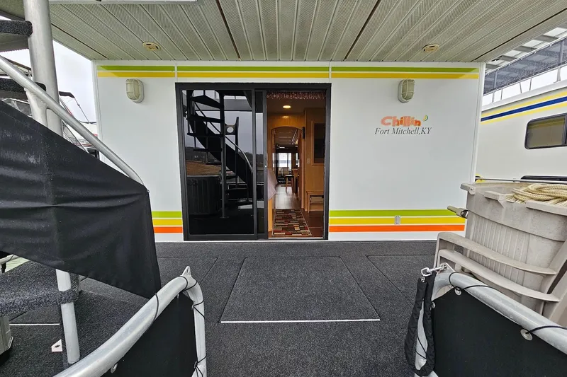Slide: The Image of Houseboat entrance with spiral staircase, labeled "Chillin', Fort Mitchell, KY," Lakeview 16x60, 2002 model. - 14