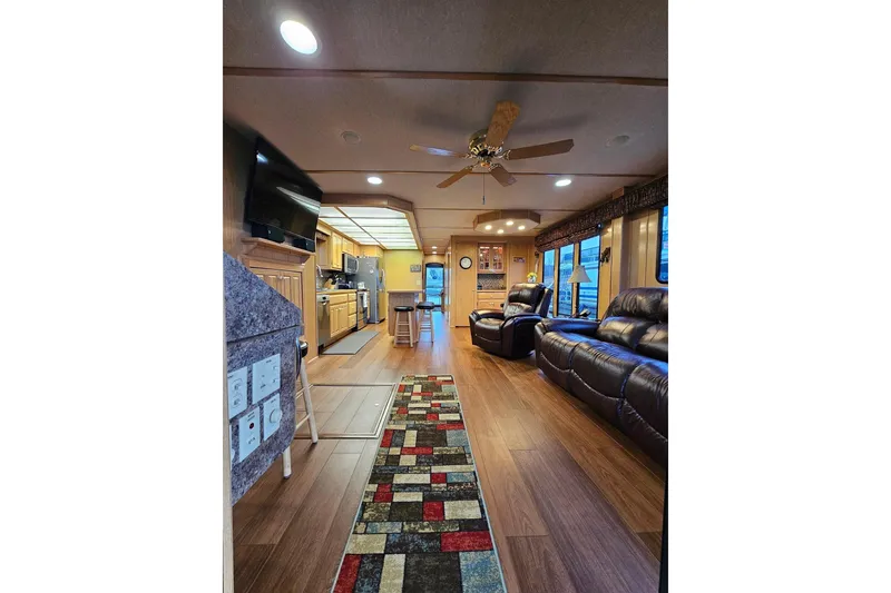Slide: The Image of Luxurious interior of 2002 Lakeview 16x60 houseboat with modern kitchen and cozy living area. - 15