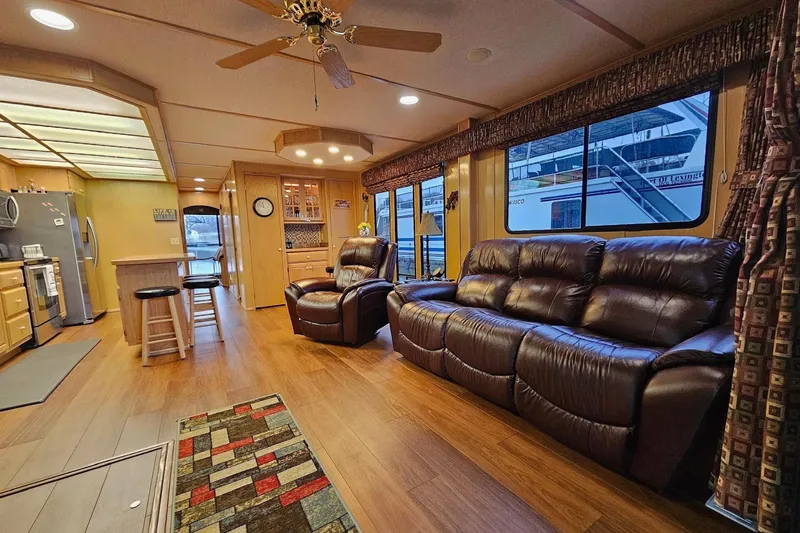 Slide: The Image of Luxurious 2002 Lakeview 16x60 houseboat interior with leather seating and modern kitchen. - 17