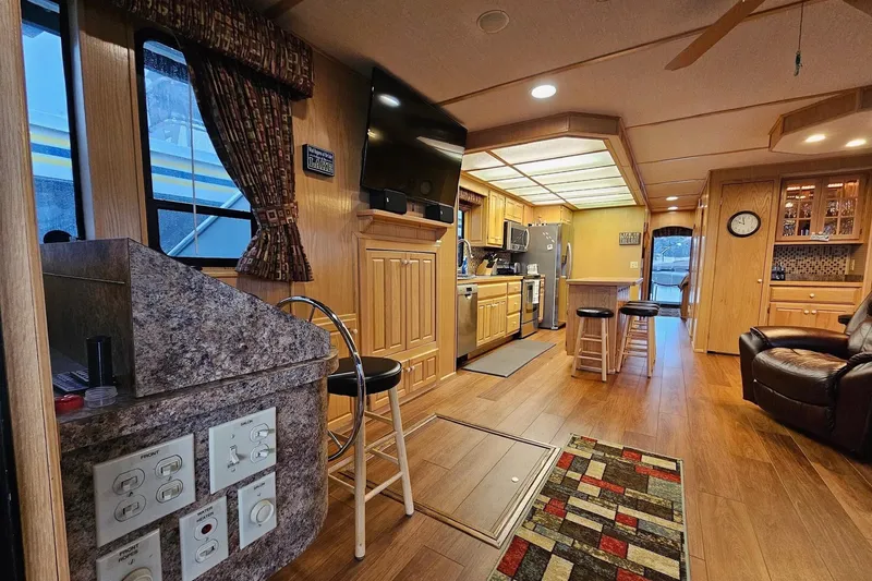 Slide: The Image of Interior of a 2002 Lakeview 16x60 houseboat with modern kitchen and cozy living area. - 18