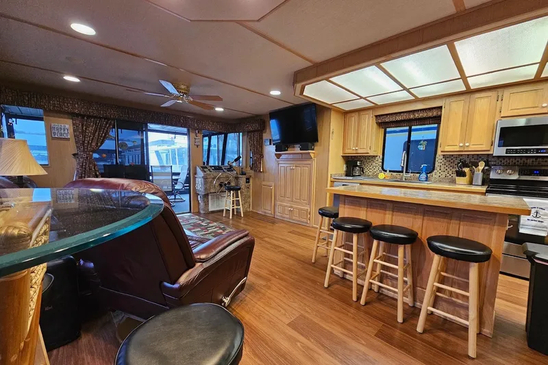 Slide: The Image of Luxurious 2002 Lakeview 16x60 houseboat interior with modern kitchen and cozy seating area. - 19