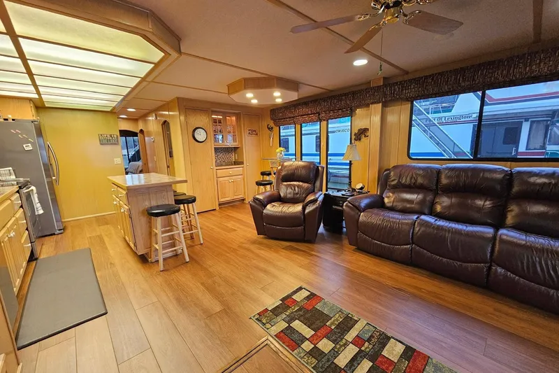 Slide: The Image of Spacious 2002 Lakeview 16x60 houseboat interior with modern kitchen and cozy living area. - 21