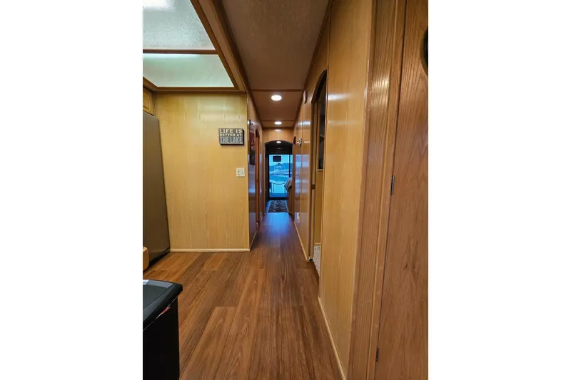Slide: The Image of Hallway of 2002 Lakeview 16x60 houseboat with wooden interior and sign. - 23