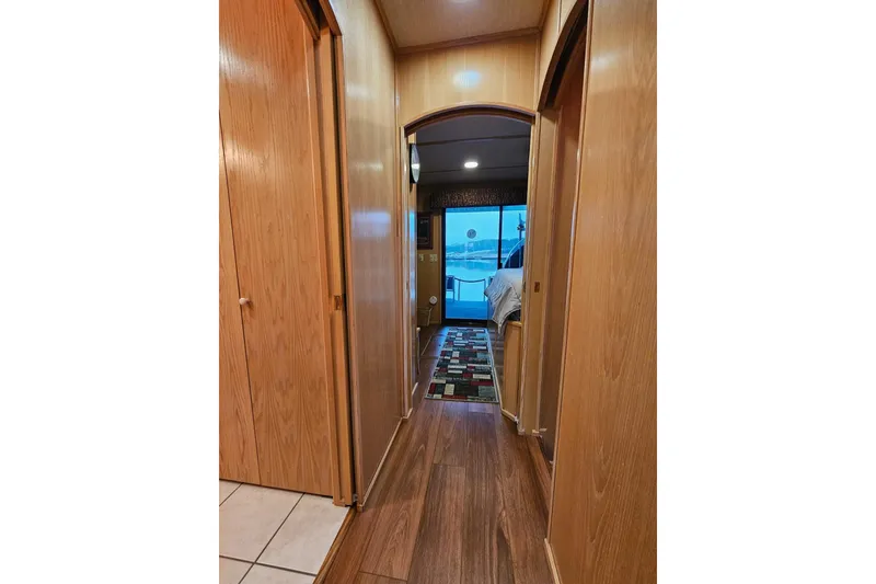 Slide: The Image of Hallway in 2002 Lakeview 16x60 houseboat with wood paneling and lake view. - 28