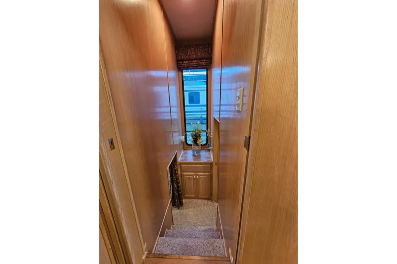 Slide: The Image of Narrow hallway in 2002 Lakeview 16x60 houseboat with wooden walls and small window. - 29