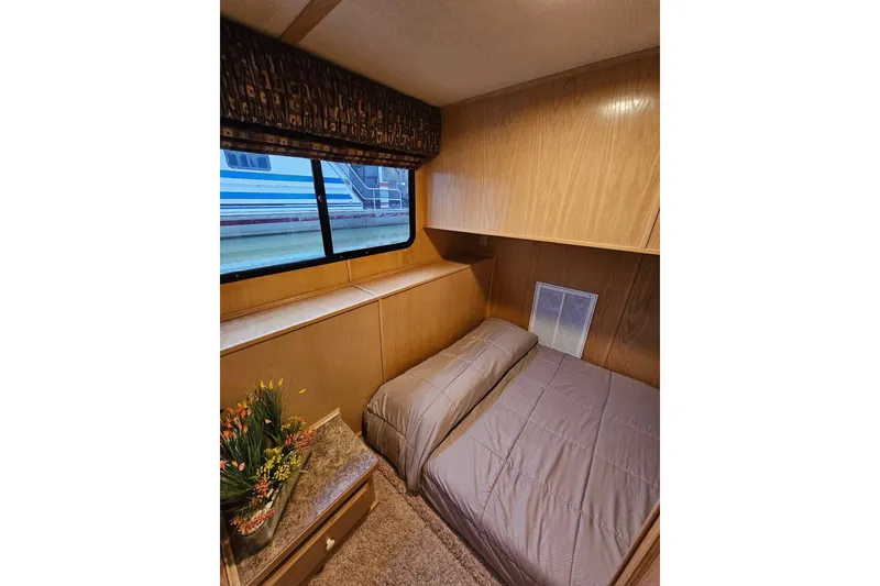 Slide: The Image of Cozy bedroom interior of 2002 Lakeview 16x60 houseboat with window view and floral decor. - 31