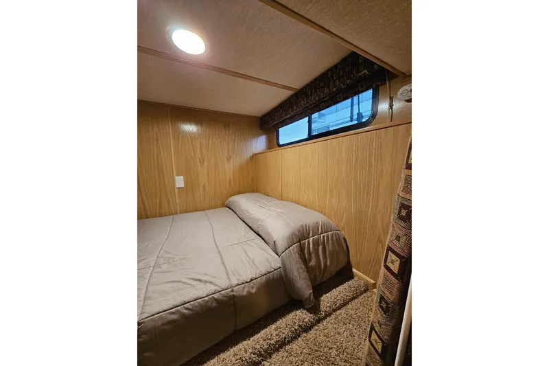Slide: The Image of Cozy bedroom in 2002 Lakeview 16x60 houseboat with wood paneling and soft lighting. - 35
