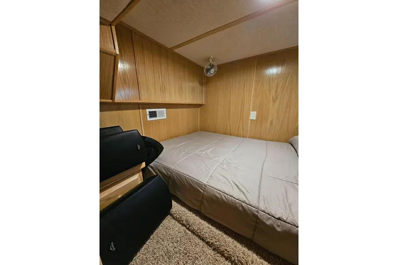 Slide: The Image of Cozy bedroom in 2002 Lakeview 16x60 houseboat with wood paneling and compact design. - 36