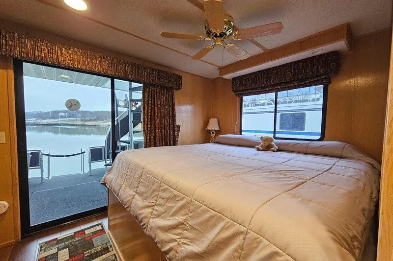 Slide: The Image of Cozy bedroom in 2002 Lakeview 16x60 houseboat with lake view and plush bedding. - 39