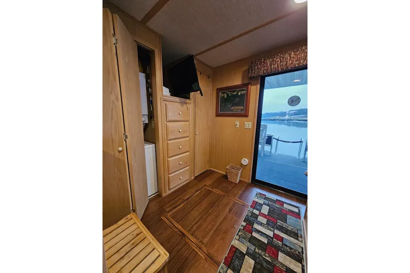 Slide: The Image of Interior of 2002 Lakeview 16x60 houseboat with wooden cabinets and lake view. - 43