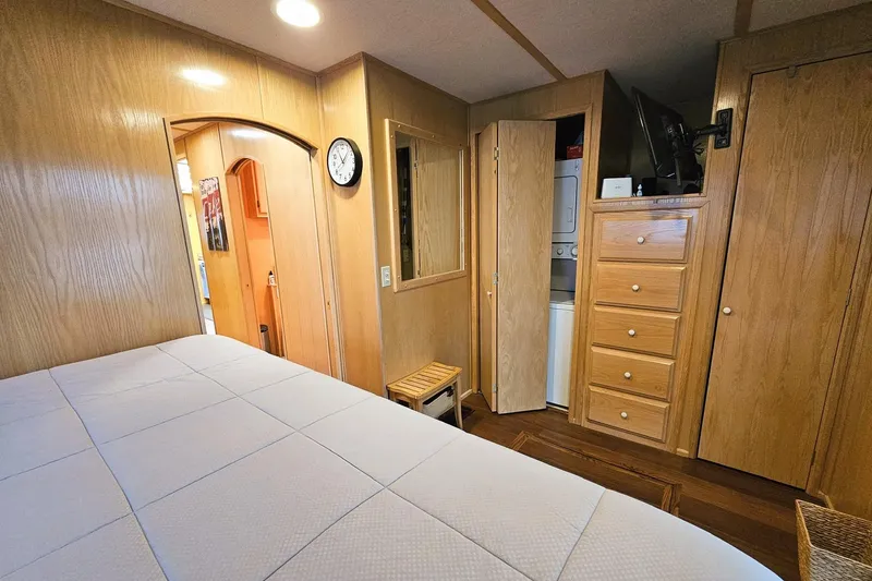 Slide: The Image of Cozy bedroom in 2002 Lakeview 16x60 houseboat with wood paneling and laundry area. - 45