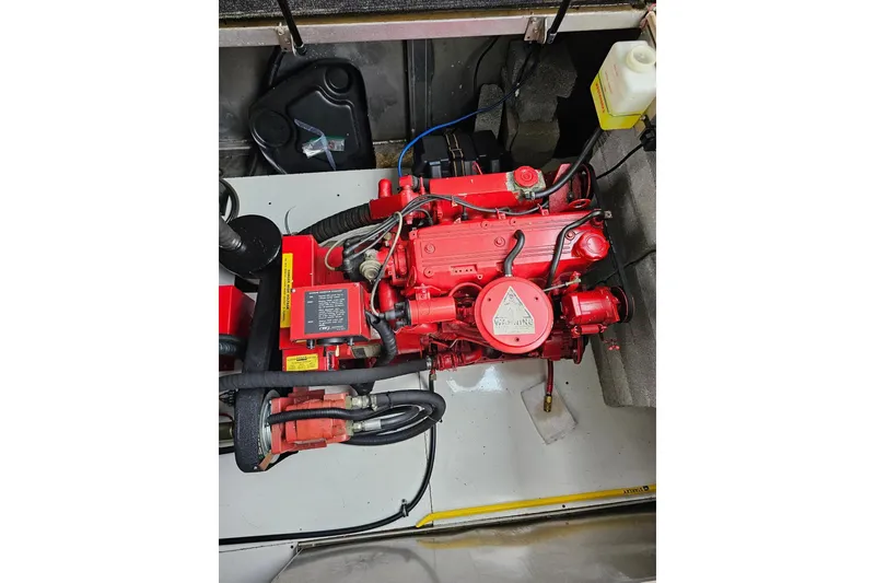 Slide: The Image of Red engine in a 2002 Lakeview 16x60 boat, surrounded by cables and components. - 48