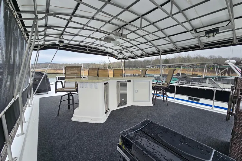 Slide: The Image of Upper deck of 2002 Lakeview 16x60 houseboat with bar and seating area. - 51